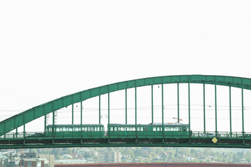 Fototapeta premium Green tram on a green bridge in the city Belgrade 