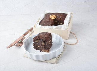 premium freshly baked dark cocoa chocolate brownie square cake with walnut in wood bento box on white marble halal food sweet dessert menu for pastry cafe shop