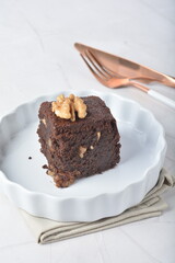 premium freshly baked dark cocoa chocolate brownie square birthday cake with walnut peanut almond in wood bento box on white marble halal food gluten free sweet dessert menu for pastry cafe shop