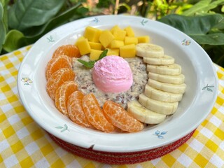 Oat overnight milk with strawberry Greek yogurt with orange, mango and banana