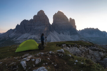 Tre Cime di Lavaredo and Rifugio Auronzo seen from Cadini di Misurina at sunrise in summer, Dolomites, Italy