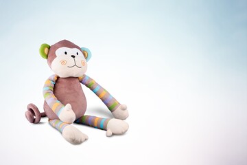 Soft fluffy cute toy on color background