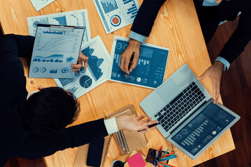 Top view analyst team discussing financial data on digital dashboard, analyzing chart and graph...