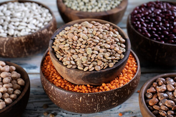 close up dried legumes green lentils in wooden bowl