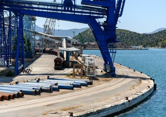 Industrial machinery for loading cargo on trains on a sunny dock