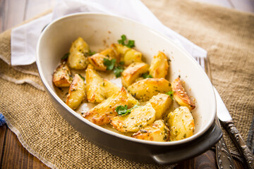 potatoes baked with sesame seeds, herbs and spices in the oven