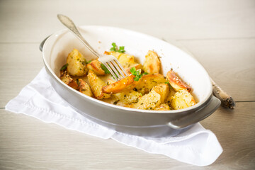 potatoes baked with sesame seeds, herbs and spices in the oven