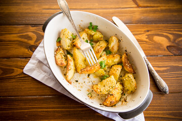 potatoes baked with sesame seeds, herbs and spices in the oven