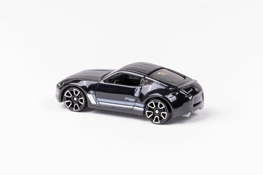 Closeup shot of a Hot Wheels black Nissan 370Z toy figure isolated on a white background
