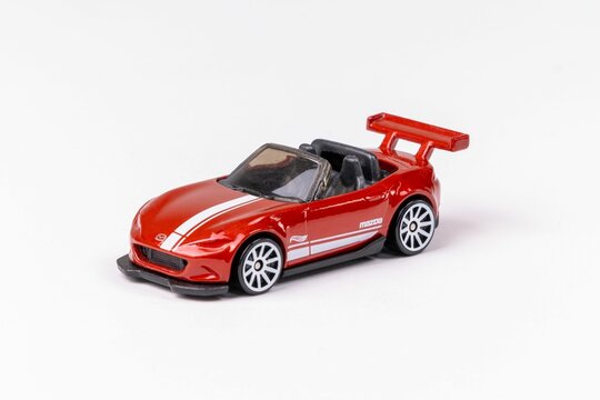 Closeup shot of a red Hot Wheels Mazda MX-5 Miata isolated on a white background