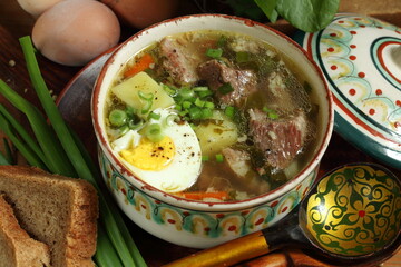 Green borscht with sour cream and rye bread