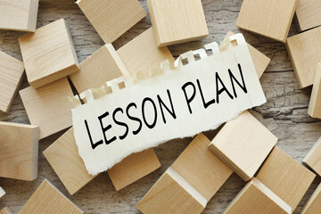 Lesson Planning text on torn paper. on wooden cubes. wooden background