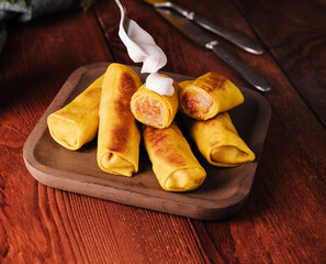 Woman adding sour cream to pancakes