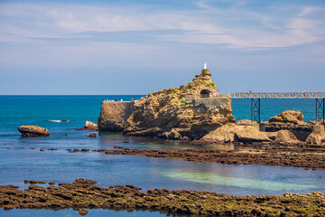 Rocher de la Vierge rock in Biarritz at low tide in France