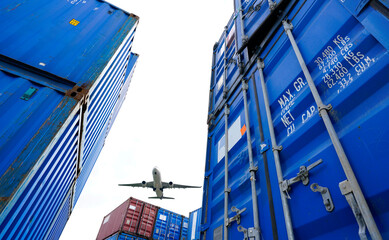 Airplane flying above container logistic. Cargo and shipping business. Container ship for import...