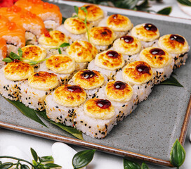 different sushi rolls on a big plate