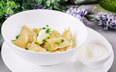 Delicious cooked dumplings and sour cream