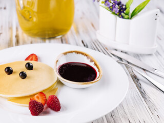 Baby cat pancake on a white plate