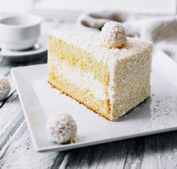 Coconut layered, raffaello cake on white plate