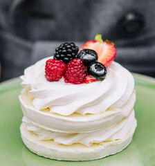 Pavlova meringue cake with fresh berries on a plate