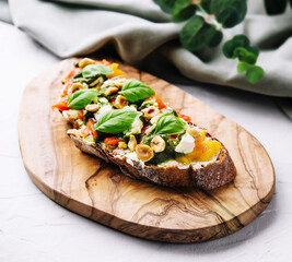 bruschetta with pesto, hazelnuts, cheese and basil