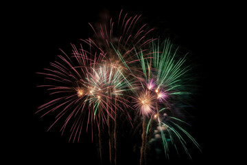 Fototapeta na wymiar Colorful new year fireworks isolated on black background backdrop
