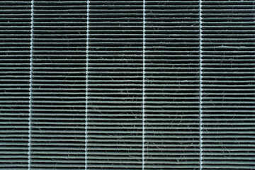 Extremely dirty used air purifier filter close up. Used dirty air purifier filter in the dusty and...