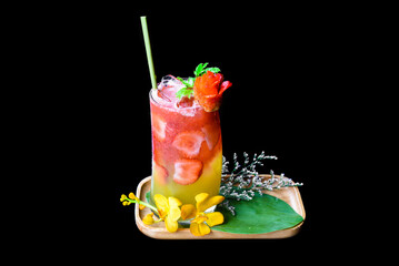Fresh summer drink with strawberry jam and orange juice isolated on black background