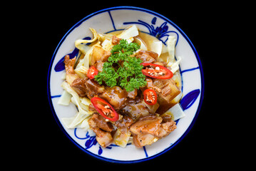 Vietnamese fried pork with ginger on black background