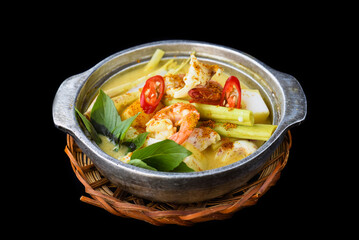 Vietnamese curry with shrimps and potato on black background for a menu