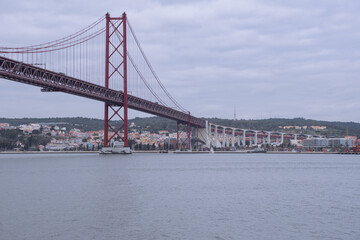 View of the 25 April bridge from the Tagus river in Lisbon (Portugal). Europe's longest bridge connecting the city of Lisbon.