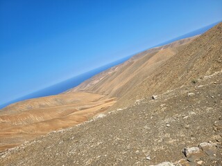 Awesome dunes with sea and cloudless sky in background