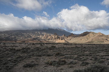 Landscape with mountains in the background and a cloudy evening day