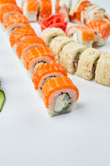 Traditional delicious fresh sushi set Philadelphia roll with salmon, smoked eel and cucumber isolated on white background. Sushi menu. Japanese asian food