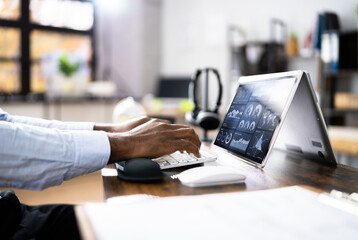 Fototapeta premium African Businessman Using Analytics Data KPI Dashboard