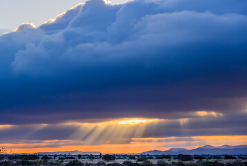 Silver Lining cloud with sunrise over desert 