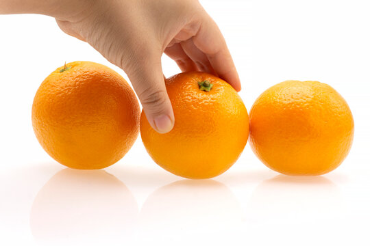 Hand Reaching for Fresh Oranges – Healthy Citrus Fruit - Powered by Adobe