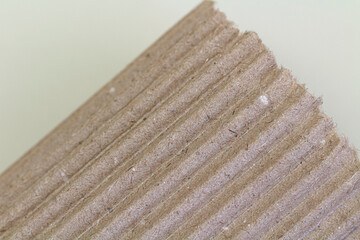 Kraft paper texture striped pattern for wrapping. texture background. Ripped piece of cardboard isolated on white background. Cardboard with torn edges, top view.