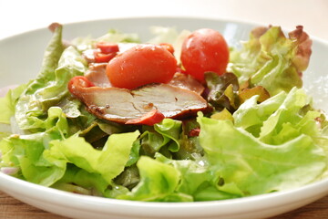 grilled slice pork fresh vegetable salad dressing Thai spicy seafood sauce on plate 