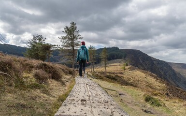 Beautiful shot of a hiker on the trail of the Sugar Loaf Mountain in Wickow, Ireland
