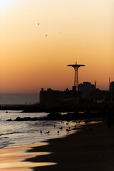 Beautiful shot of a bright orange blue sunset sky over silhouettes on Brighton Beach