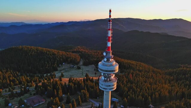 Tower Snezhana on peak of Snezhana covered with spruce forests in Rhodope mountains