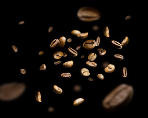 Coffee beans fly and levitate in space. Isolated on black
