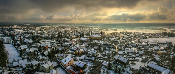 View of the snow-blanketed roofs of a city