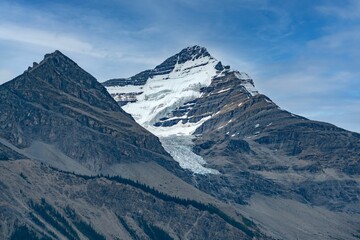Fototapeta na wymiar Snow-capped peaks of Robson Mountain under a blue sky in Canada.