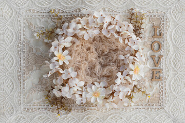 Newborn digital backdrop with wreath of handmade flowers and word love on boho background. Newborn...
