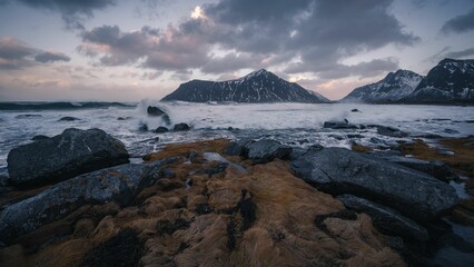 Majestic seascape with mountains and dramatic clouds in the background
