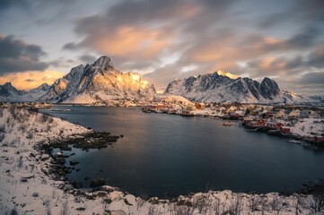 Stunning view of houses by the sea with mountains in the background in Lofoten Islands, Norway