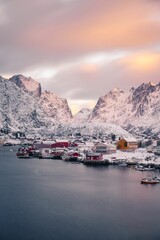 Stunning view of houses by the sea with mountains in the background in Lofoten Islands, Norway