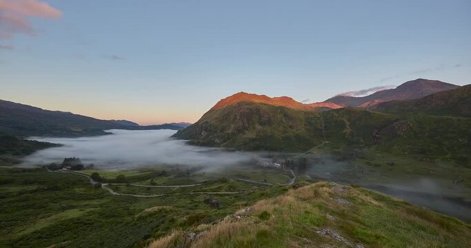 Time Lapse of morning fog and sunrise from Snowdon lookout with the Snowdon mountain range in background, Wales, UK